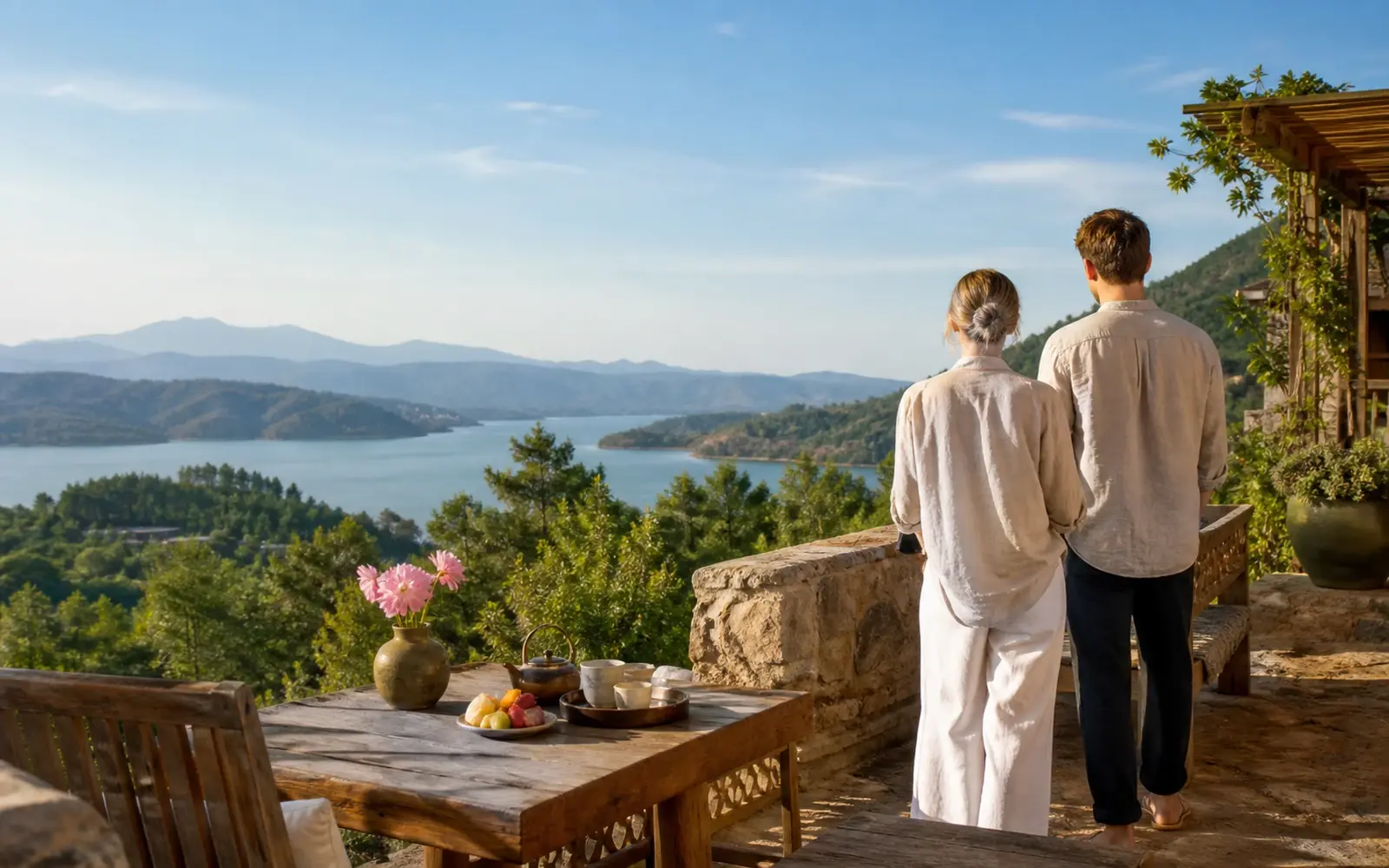 A couple overlooking a quiet lake from a stone terrace — illustrative route image